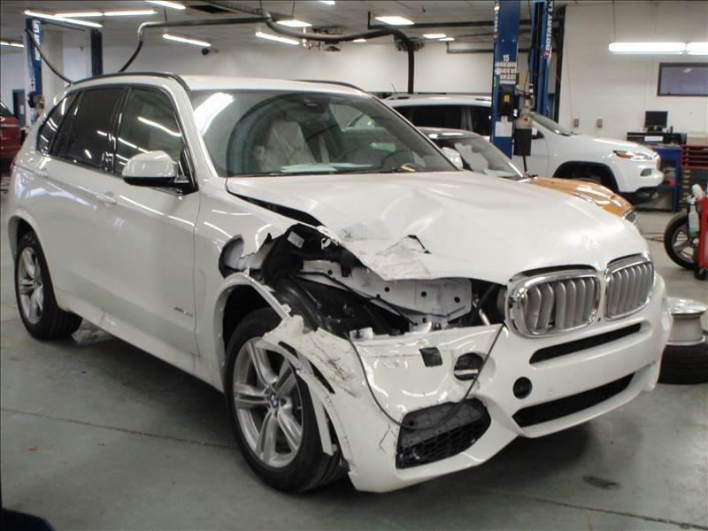 Broken white BMW SUV