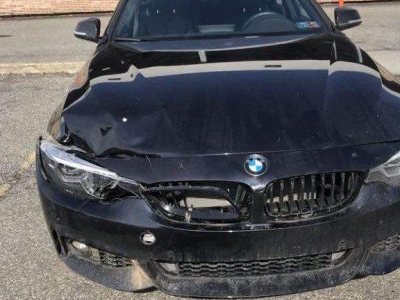 Front of black BMW with damage