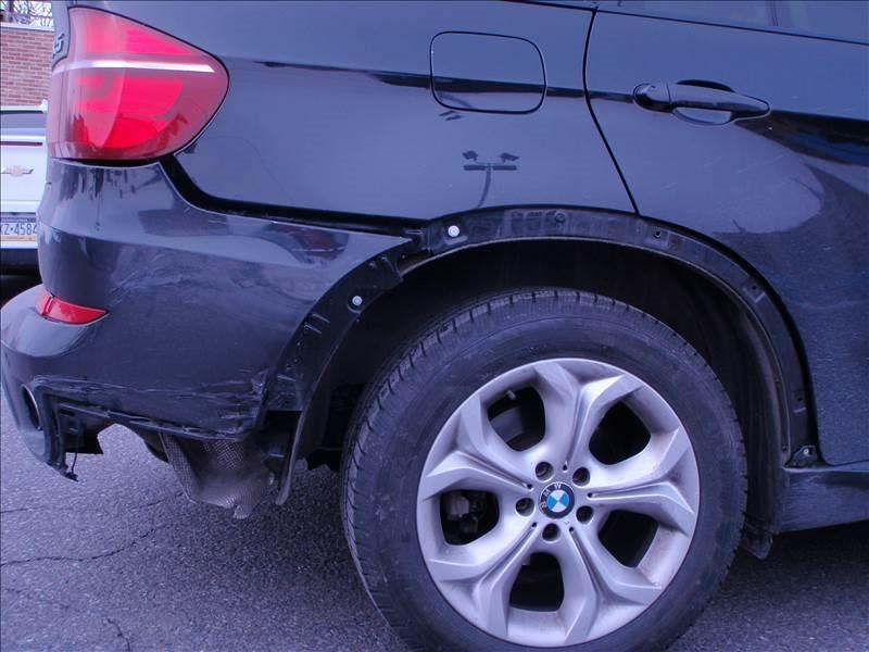 close up of right back wheel on BMW suv with damage